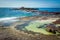 Female in bikini relaxing in ocean rockpools