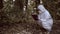 Female biologist analyzing forest leaves filling laboratory report, radiology