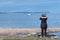 Female bird watcher by the coast