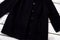 Female black buttoned coat.