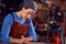 Female Blacksmith Wearing Headscarf Working On Design In Forge