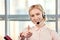 Female blond mature call center operator showing thumbs up.
