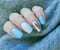 female blue hand manicure, modern stylish sweater winter creative