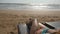 Female body on chaise-longue relaxing and enjoying during summer vacation on empty sandy ocean beach. Young woman lying