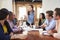 Female Boss Addressing Office Workers At Meeting