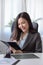 Female boss reading a book, taking notes on her diary in the office