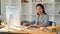 Female boss sits at her private office desk and working on pc computer