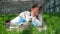 Female botanist uses microscope while working with sprouts.