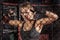 Female boxer posing inside a boxing cage.