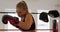 Female boxer practicing boxing in a boxing ring 4k