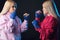 Female boxer sparring partners in blue handwraps at a boxing studio.