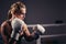 Female Boxer wearing gloves posing in boxing studio