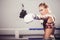 Female Boxer wearing gloves posing in boxing studio