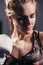 Female Boxer wearing gloves posing in boxing studio