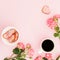 Female breakfast with roses flowers, sweet cookies and cup of coffee on pink background. Flat lay, top view.