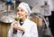 Female brewer sniffing granulated hops in glass in brewery