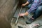 Female bricklayer checking floor with a level