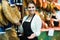 Female brunette selling jamon in delicatessen store