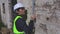 Female builder checking wall with spirit level