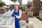 Female builder with hollow concrete block in warehouse