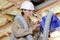 female builder inspecting ventilation system