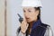 Female builder talking into walkie talkie