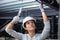 female builder working on ceiling joists