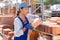 Female builder working in outdoor storage