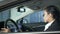 Female in business suit sitting in car being on duty, national security, agent