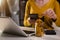 Female businessman hand puting coins in glass for saving money.