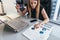 Female businesswoman readind financial report analyzing statistics pointing at pie chart working at her desk