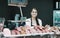 Female butcher with wurst and bologna in meat store counter