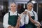 Female butchers processing sausages