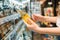 Female buyer choosing a beer in supermarket