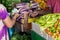 Female buyer paying with cash after buying vegetables at the Male market in Maldives