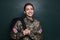 Female cadet with backpack near chalkboard. Military education