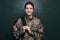 Female cadet with backpack near chalkboard. Military education