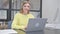 Female Call Center Employee with Headset Smiling at Camera