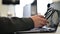 A female call center operator removes the headset and puts it on the laptop keyboard at the end of workday. Woman`s hand