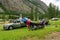 Female camper drying wet clothes after heavy storm in mountain camping.