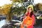 Female camper with sleeping bag near beautiful lake.