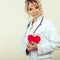 Female cardiologist with red heart.