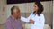 Female cardiologist in uniform talk to elderly male patient