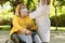 A female caregiver adjusting a surgical mask on a mature woman using a wheelchair. safety concept