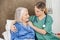 Female Caretaker Comforting Senior Woman