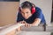 Female Carpenter Cutting Wood With Tablesaw