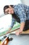 Female carpenter installing wood floor