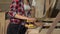 Female carpenter sanding wood at her workshop