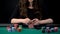 Female casino player checking cards combination, woman taking risk in poker game