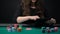 Female casino player checking cards and raising, woman taking risk in poker game